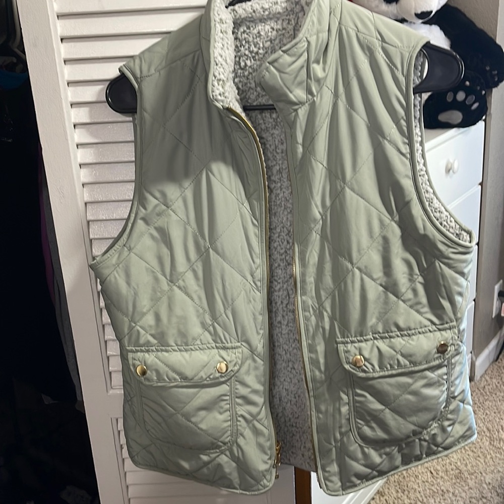 Thick reversible vest. White fuzzy and green on one side. Plain green on other